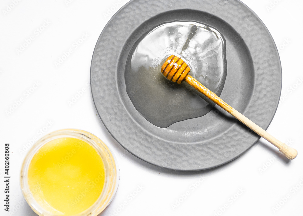 Honey dipper in a plate Honey dipper in a plate