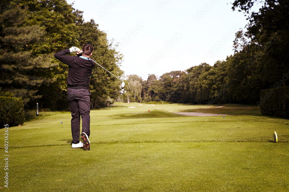 Golfer Hitting Stroke Rear View
