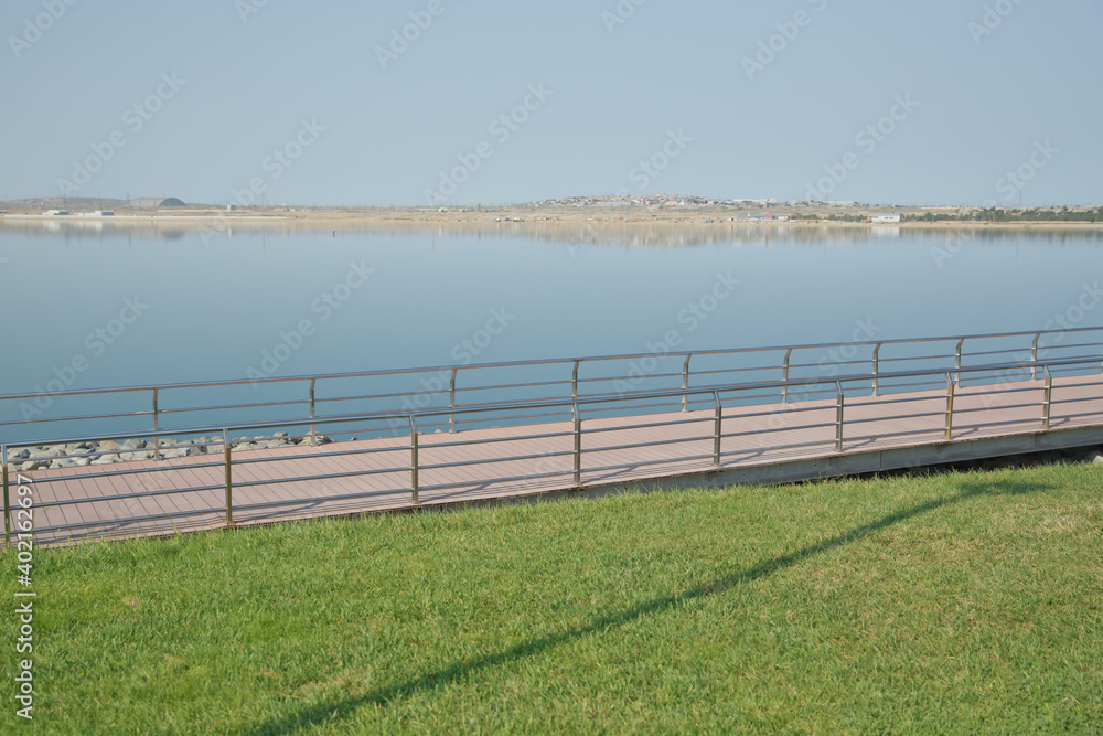 Boyukshor Lake in Baku Azerbaijan . According to geological data, the average depth of the water in the lake is 3.40-3.95 meters . An oval bridge from iron and wood on the edge of the lake .