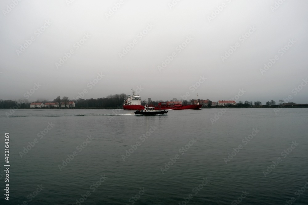 The ship goes to sea in the rain, the town of Baltiysk, Kaliningrad region, Russia The ship goes to sea in the rain, the town of Baltiysk, Kaliningrad region, Russia