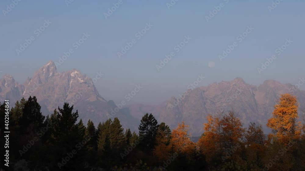 Full Moon Over Teton Mountains In Autumn At Dawn Full Moon Over Teton Mountains In Autumn At Dawn