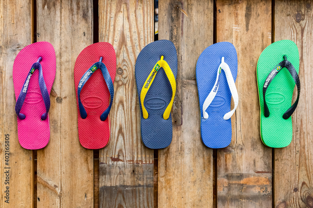 Branded flip flops in various colours on display at Camden market in