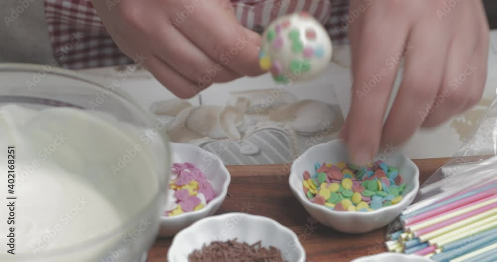 the making of cake pops with a melted chocolate coating the making of cake pops with a melted chocolate coating