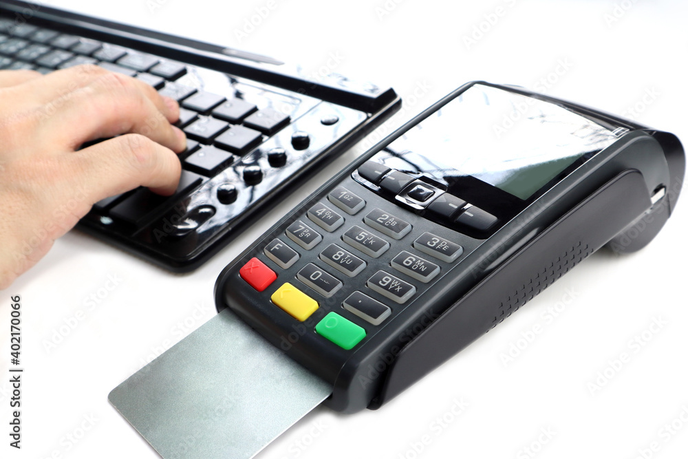 credit card reader pos machine with a credit card inside and keyboard are isolated on white background in the retail shopping grocery store department mall during buying and selling process credit card reader pos machine with a credit card inside and keyboard are isolated on white background in the retail shopping grocery store department mall during buying and selling process