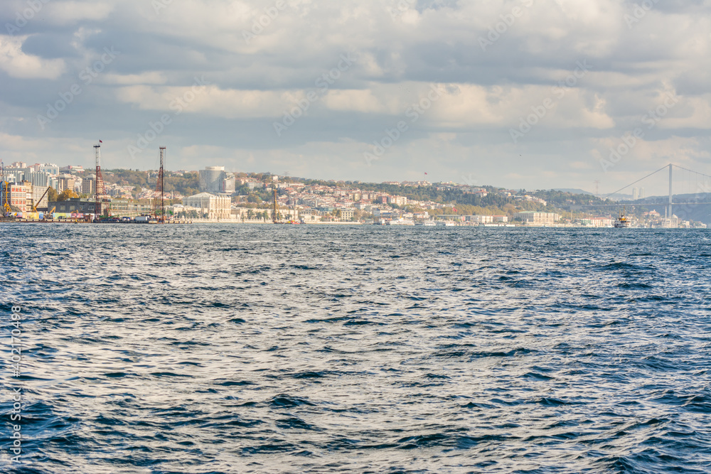 Cityscape of  Golden horn with ancient and modern buildings in Istanbul Turkey from the Bosphorus strait on a sunny day with background cloudy sky