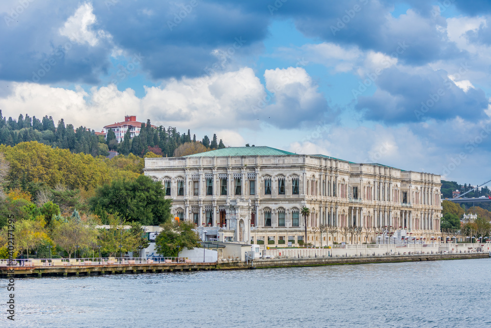 Ciragan Palace in the Bosphorus strait in Istanbul Turkey from ferry on a sunny day with background of cloudy sky