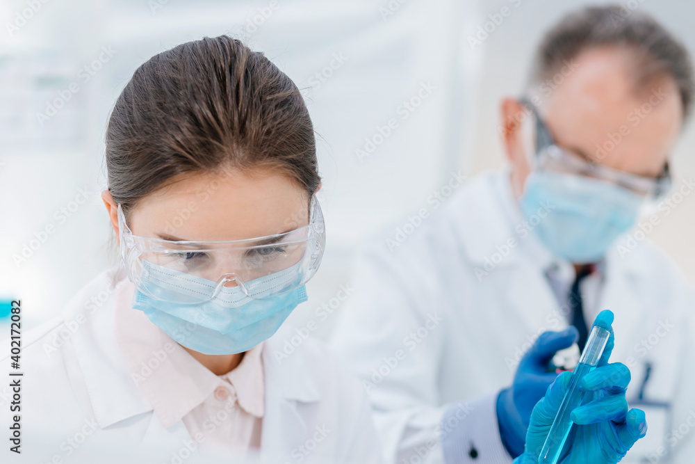 close up. female scientist with a test tube in her hands. close up. female scientist with a test tube in her hands.