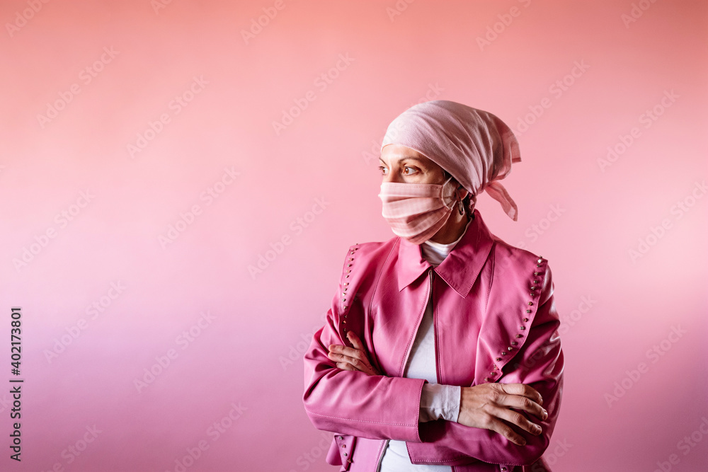 Woman with headscarf and pink mask, cancer patient. Woman with headscarf and pink mask, cancer patient.