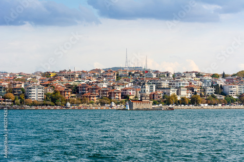 Cityscape of  Golden horn with ancient and modern buildings in Istanbul Turkey from the Bosphorus strait on a sunny day with background cloudy sky © zz3701