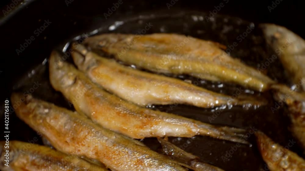 cooking process.sea fish fried in oil in a pan.close-up. cooking process.sea fish fried in oil in a pan.close-up.