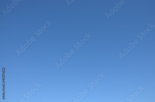 Clear blue sky background without clouds and contrails, a sunny day, copy space
