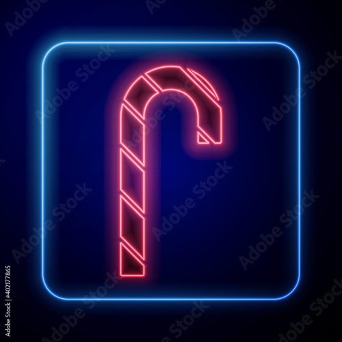 Glowing neon Christmas candy cane with stripes icon isolated on blue background. Merry Christmas and Happy New Year. Vector.