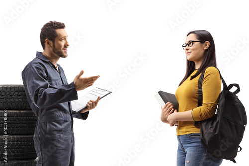Auto mechanic worker talking to a female student