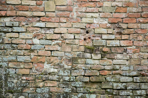 Old brick wall - soaked and damaged