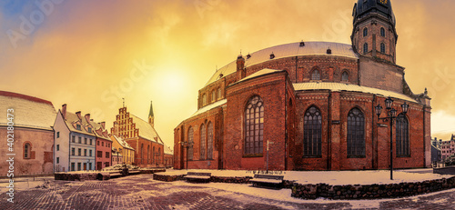 Panoramic view of St. Peter's Church and surrounded historical buildings during sunset in old town in Riga, Latvia
