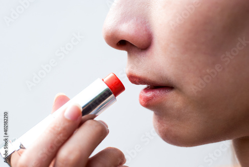 woman applying lip gloss
