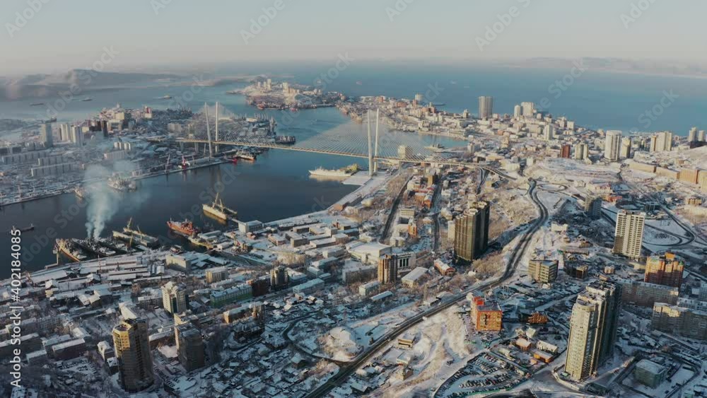 Winter view from a drone of a city with hills at sunrise Winter view from a drone of a city with hills at sunrise