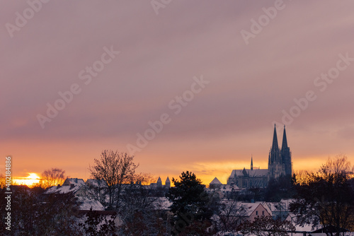 The cathedral St. Peter in Regensburg on cold winter morning in December with fresh snow on the roofs and spires © Robert Ruidl