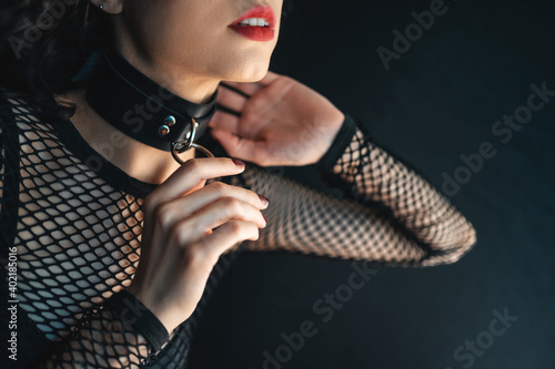 close up of sensual female with red lips and leather bondage collar choker photo