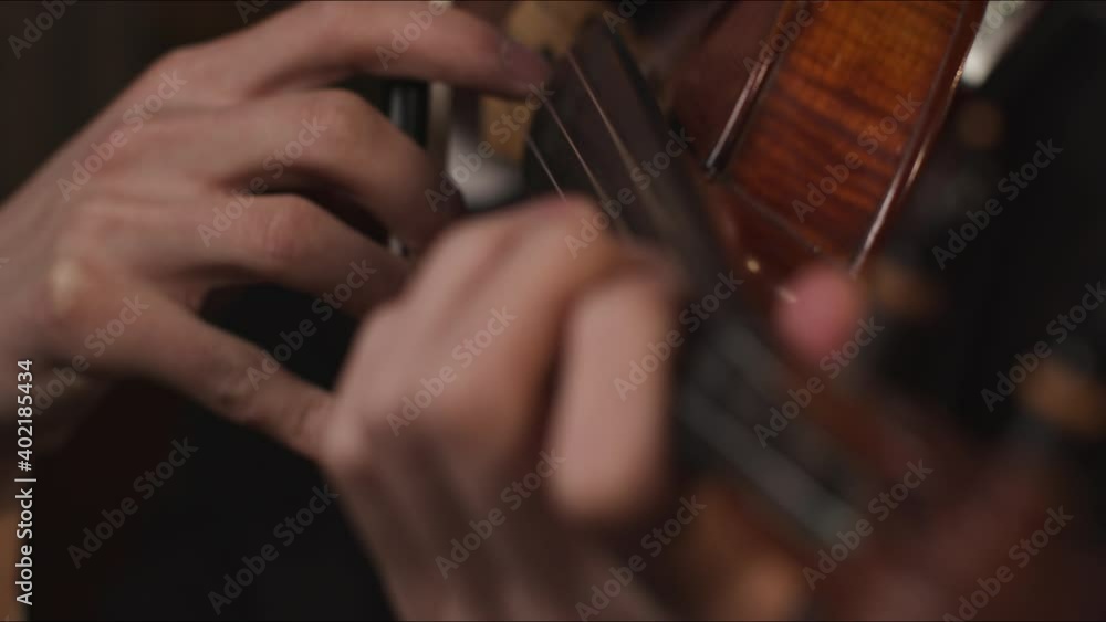 Close Up Hands Of Male Violinist Plucking Strings On Violin Close Up Hands Of Male Violinist Plucking Strings On Violin