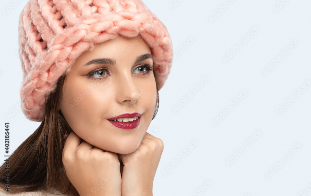 Brunette girl with beautiful makeup, with clean skin, long hair, in a pink hat. New Year concept Brunette girl with beautiful makeup, with clean skin, long hair, in a pink hat. New Year concept