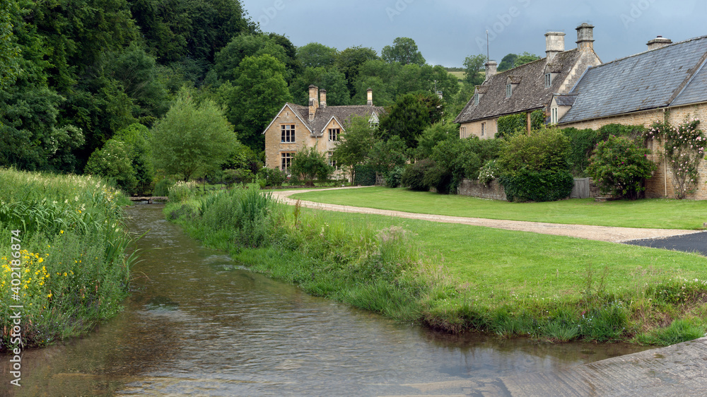 GLOUCESTERSHIRE, UK:  View along small stream and ford toward large stone house