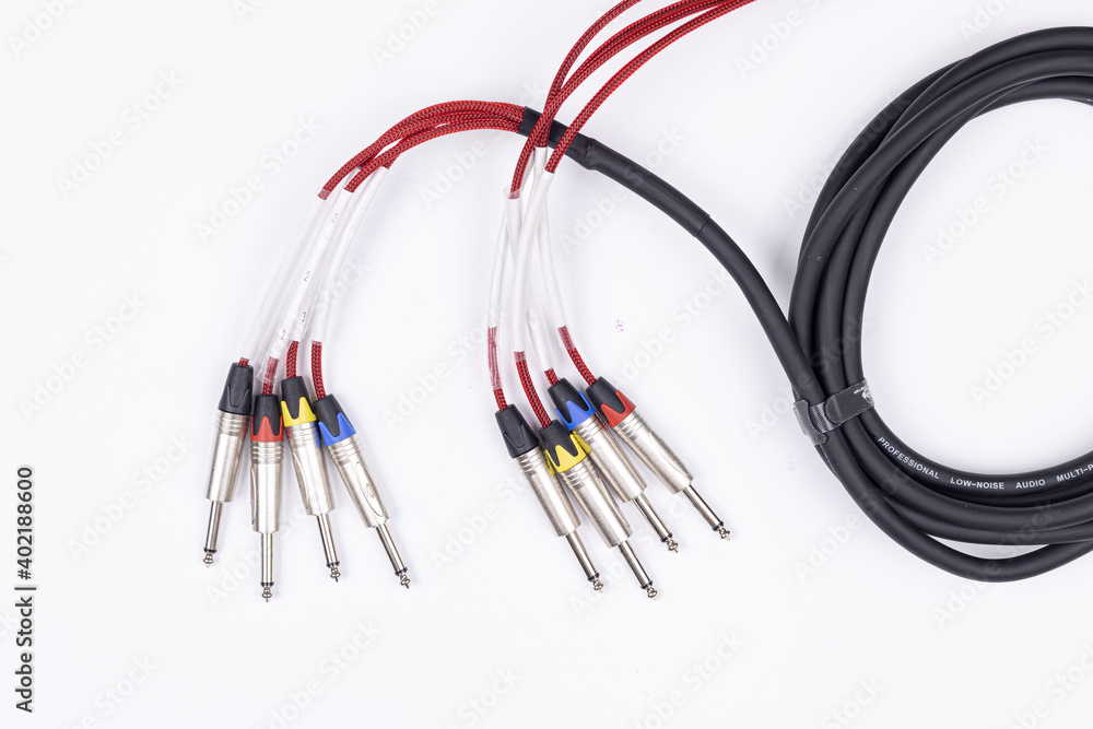 Audio guitar and microphone cable isolated above white background Audio guitar and microphone cable isolated above white background