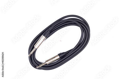Audio guitar and microphone cable isolated above white background