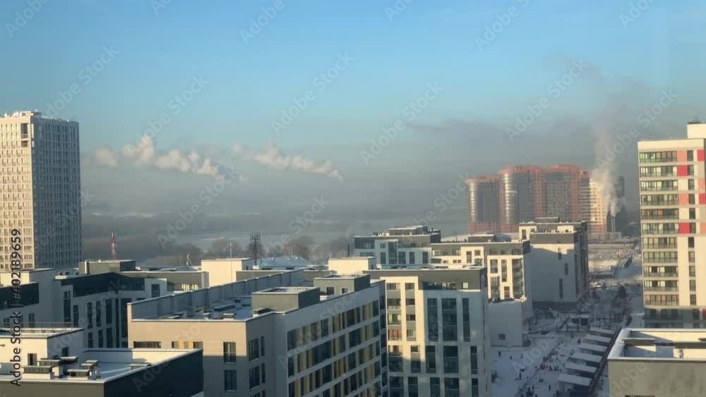 Winter sunrise over the city. Smoke belching from the chimney Winter sunrise over the city. Smoke belching from the chimney