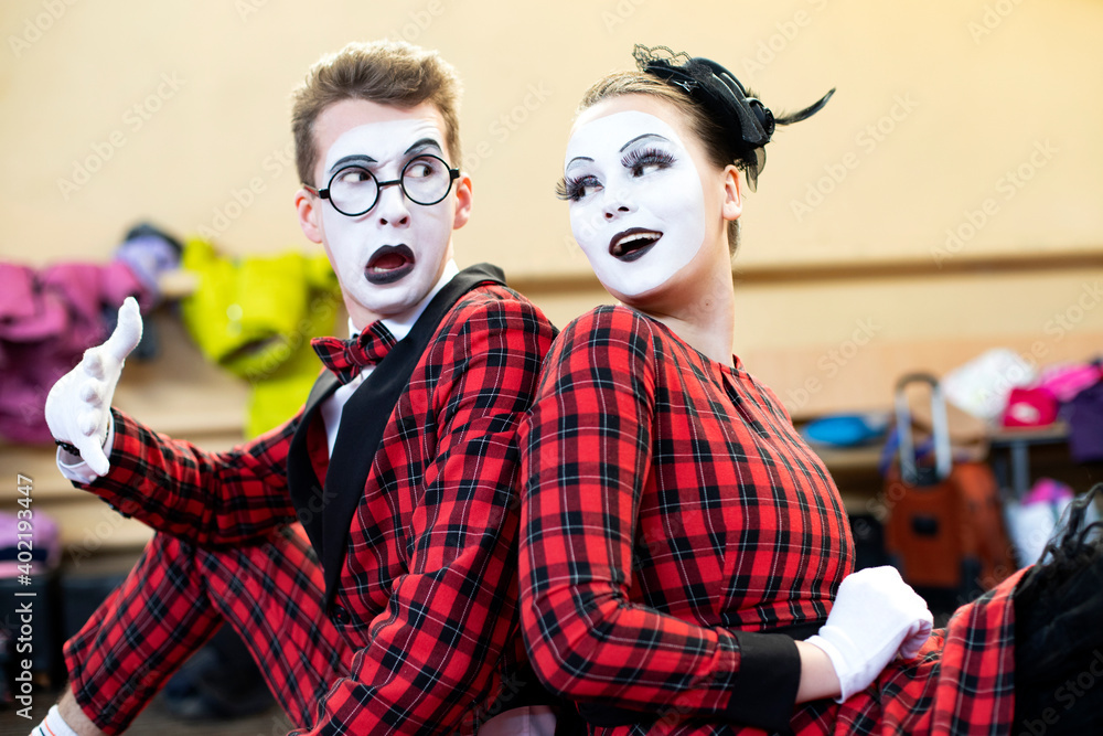 Fototapeta premium mimes guy and girl sit together and grimace