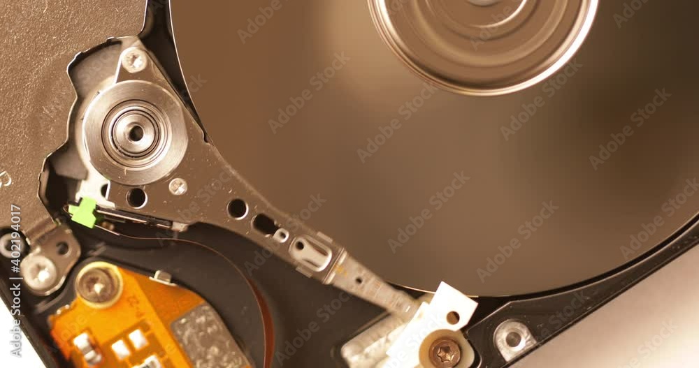 Data storage technology. Hard drive. The head reads data from a magnetic disk. Macro Data storage technology. Hard drive. The head reads data from a magnetic disk. Macro