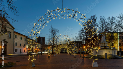 The Parish Church of Santa Maria Assunta and the Piazza Vittorio Emanuele II in the center of Bientina, Italy, festooned with Christmas lights photo