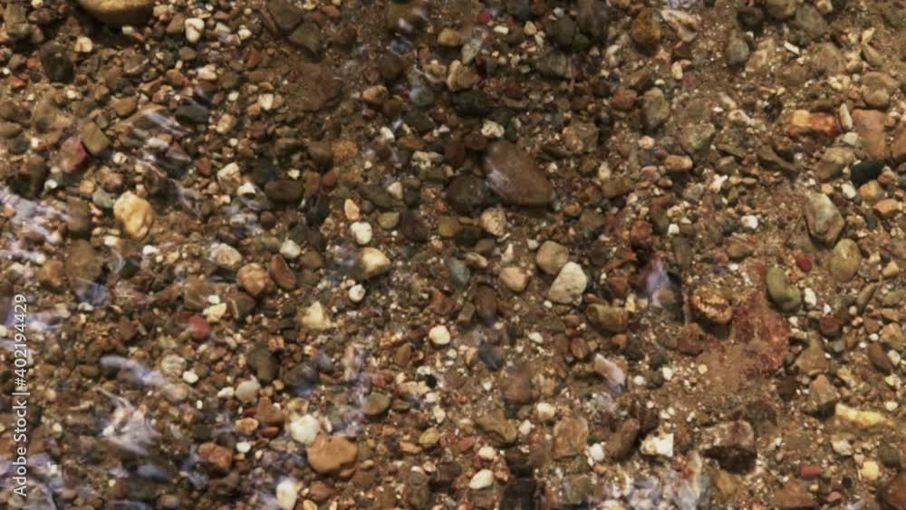 rocks at the bottom of a transparent stream rocks at the bottom of a transparent stream