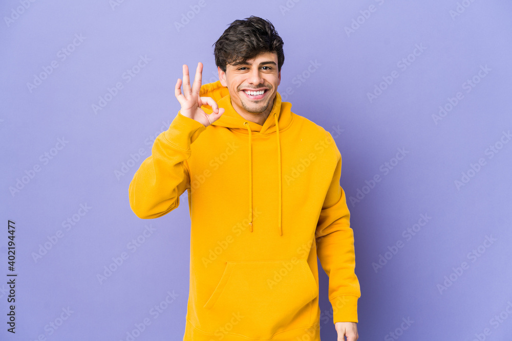 Young cool man cheerful and confident showing ok gesture. Young cool man cheerful and confident showing ok gesture.