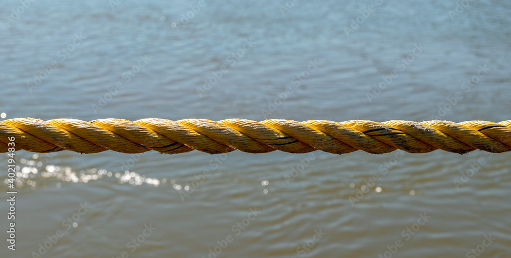 Mooring Rope stretched taut over the water Stock Photo