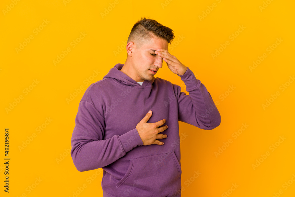 Young handsome caucasian man isolated having a head ache, touching front of the face. Young handsome caucasian man isolated having a head ache, touching front of the face.