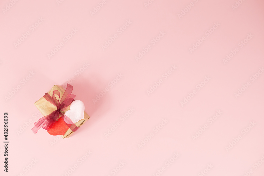 Two hearts and gift on a pink background. Valentine's Day. March 8. Two hearts and gift on a pink background. Valentine's Day. March 8.