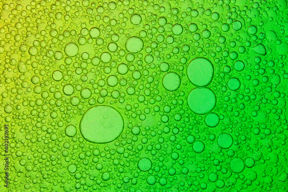 Mixture of olive oil and water on yellow and green Background, macro shot, abstract background image,