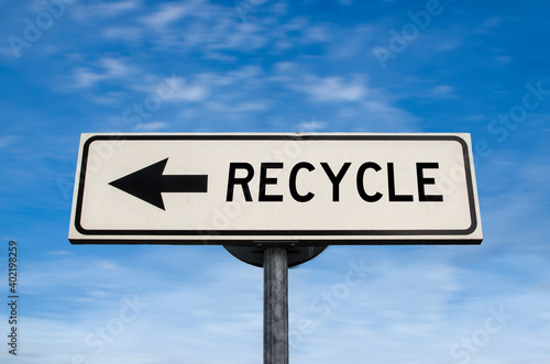 Recycle road sign, arrow on blue sky background. One way blank road sign with copy space. Arrow on a pole pointing in one direction.