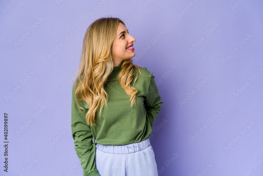 Young caucasian blonde woman relaxed and happy laughing, neck stretched showing teeth. Young caucasian blonde woman relaxed and happy laughing, neck stretched showing teeth.