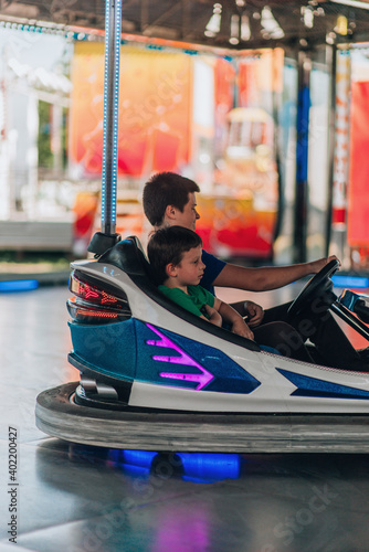 The riding cars on a fun fair dodgem attraction