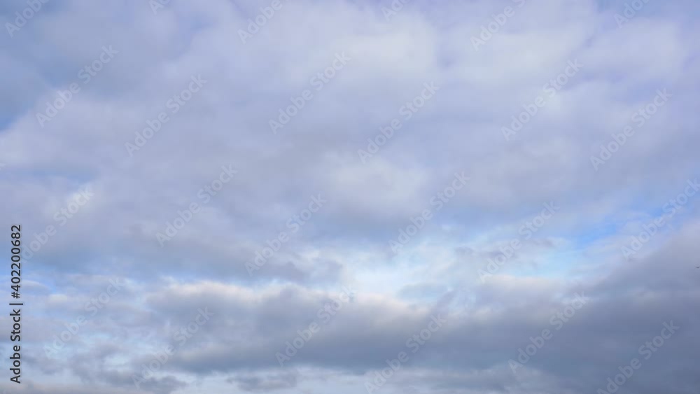 Clouds moving overhead from right to left side in real time. The blue sky is shining through. Clouds moving overhead from right to left side in real time. The blue sky is shining through.