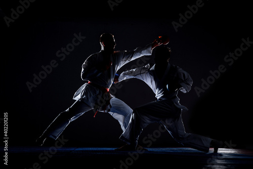 Karate martial arts fighter in white kimono in the gym photo