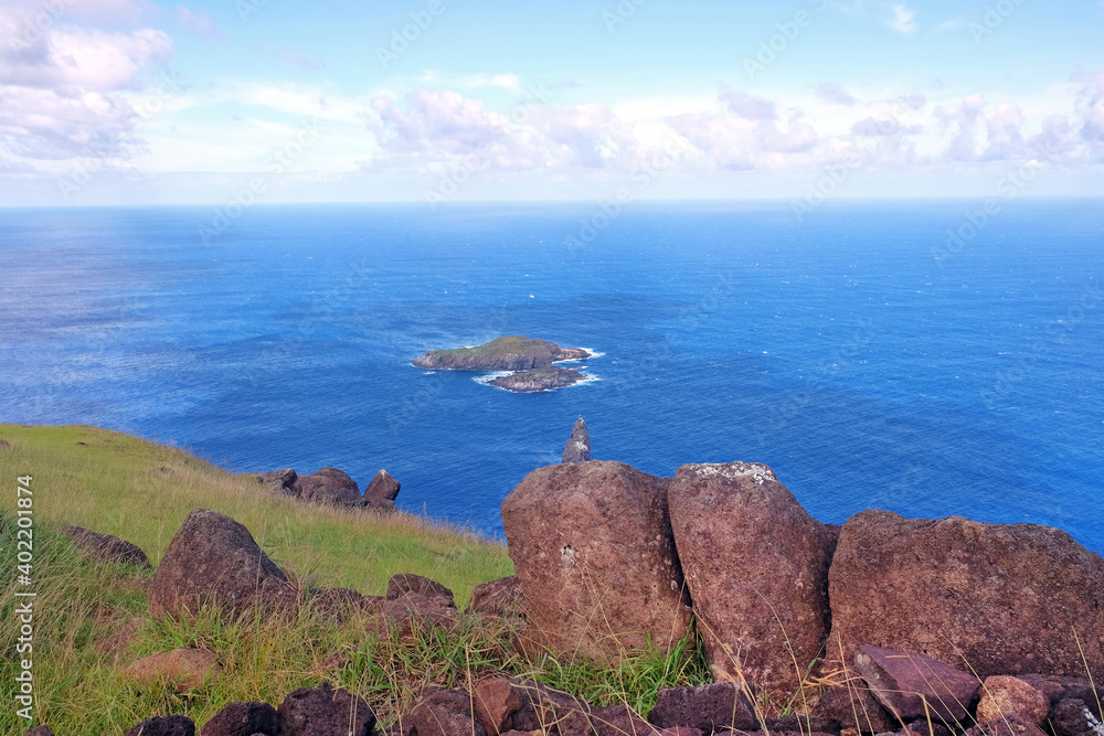 Ocean view from the archaeological site on the Rano Kau volcano, on Easter Islan, against a blue clear sky. Ocean view from the archaeological site on the Rano Kau volcano, on Easter Islan, against a blue clear sky.