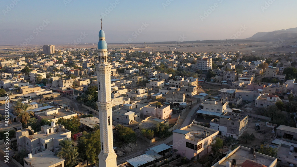 Fototapeta premium Mosque Tower minaret in Jericho city with Birds- aerial view Drone view of Jericho city,sunset, Jordan Valley, Israel/palestine 