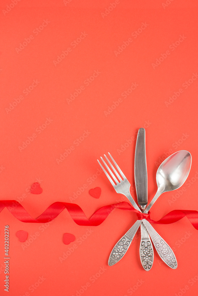 Festive table setting for Valentine's day on the red surface Festive table setting for Valentine's day on the red surface