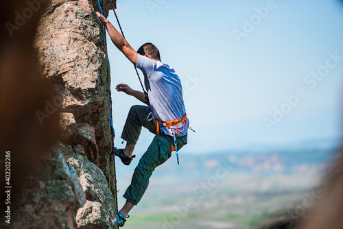 Rock climber battles his way up