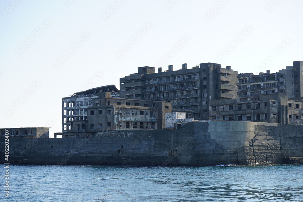 Abandoned Industrial houses and buildings of Gunkanjima or Battleship island, Ghost Island, from ferry boat in Nagasaki, Japan - 長崎 軍艦島