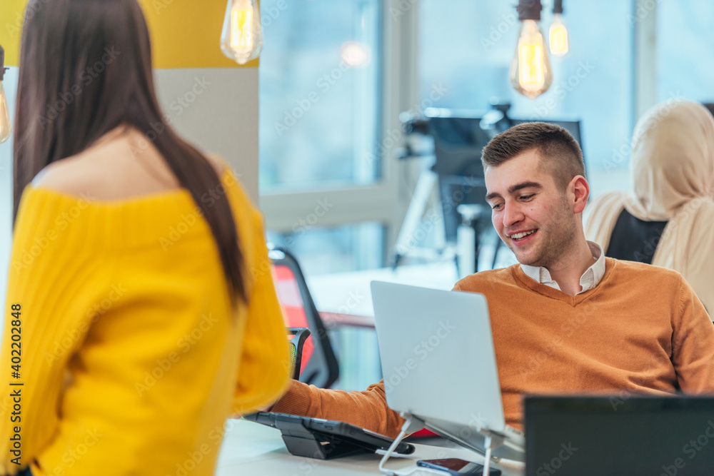 Team working on a digital project. Group of coworkers working in a startup business environment. Employees having fun in a modern office. Team working on a digital project. Group of coworkers working in a startup business environment. Employees having fun in a modern office.