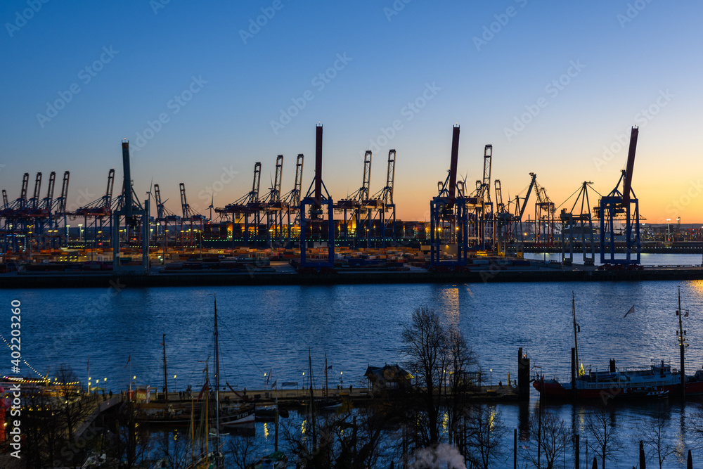 Hamburg, Germany: Shipyard cranes at the docks in the port  in the twilight
